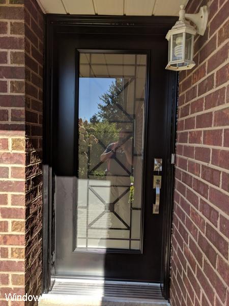 Modern front door store. Single entry insulated steel exterior. Black. Latest Century iron glass inserts